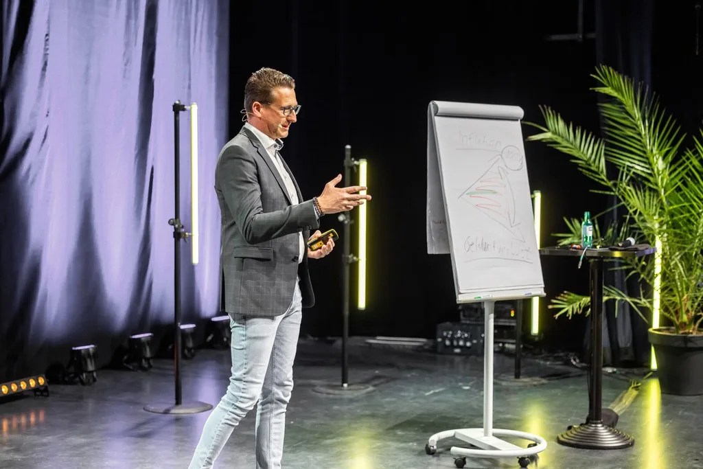Christian Riebel erklärt am Flipchart, wie Anleger ihr Vermögen schützen